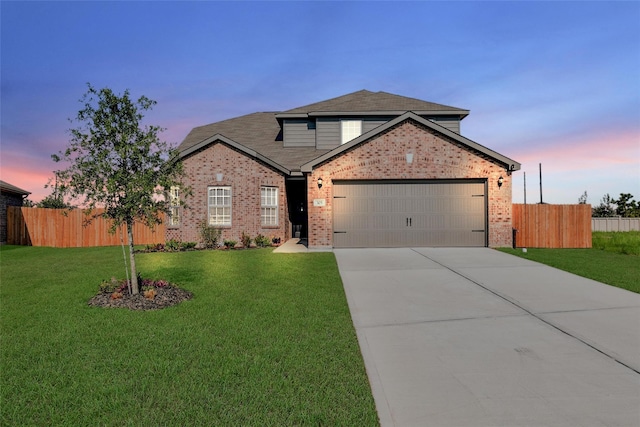 view of property with a garage and a lawn