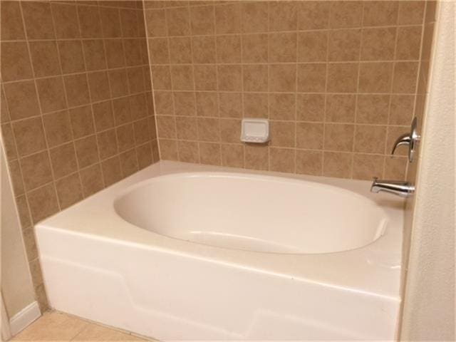 full bathroom featuring a shower, tile patterned flooring, and a bathing tub