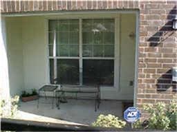 doorway to property featuring brick siding and a patio