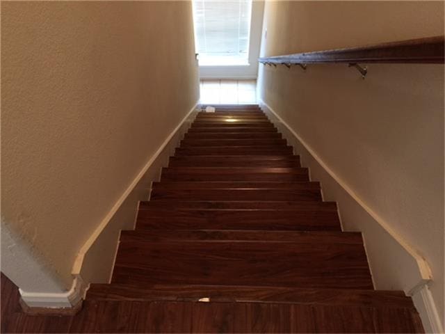 stairway with wood finished floors