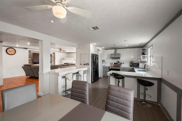 dining room featuring dark hardwood / wood-style flooring, sink, and a textured ceiling