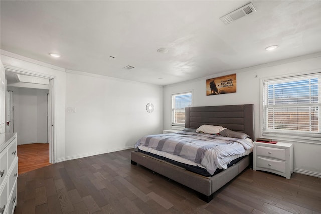 bedroom with multiple windows, dark hardwood / wood-style flooring, and ornamental molding