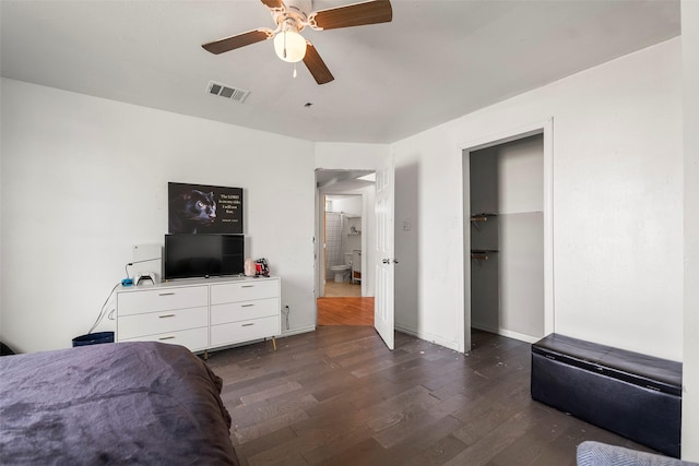 bedroom with dark wood-type flooring, ceiling fan, and a closet