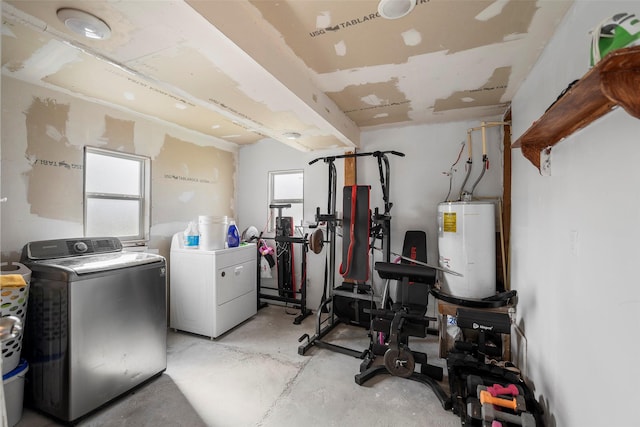 clothes washing area with water heater and washing machine and clothes dryer