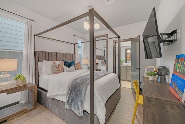 bedroom featuring connected bathroom and multiple windows