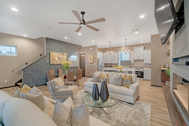 living room with ceiling fan and light hardwood / wood-style floors