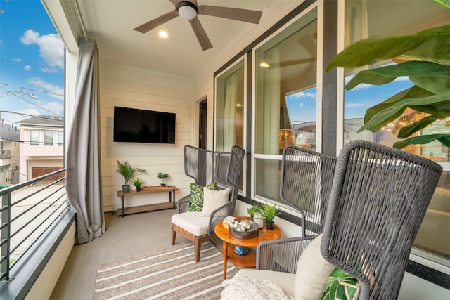 sunroom featuring ceiling fan