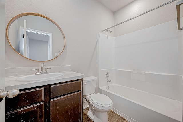 full bathroom with hardwood / wood-style flooring, tub / shower combination, toilet, and vanity