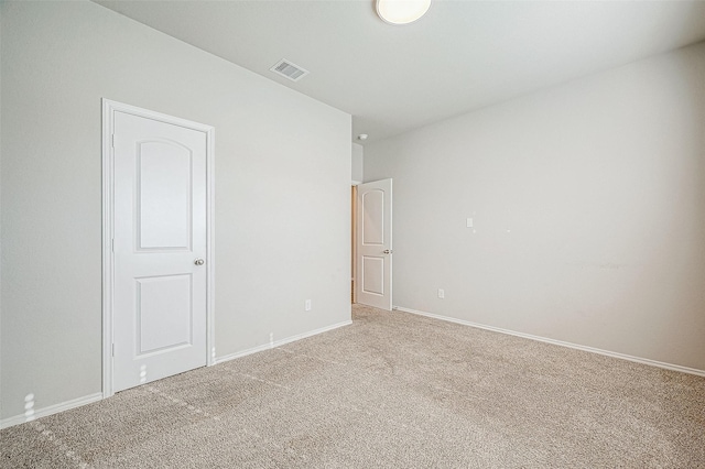 unfurnished room featuring light carpet