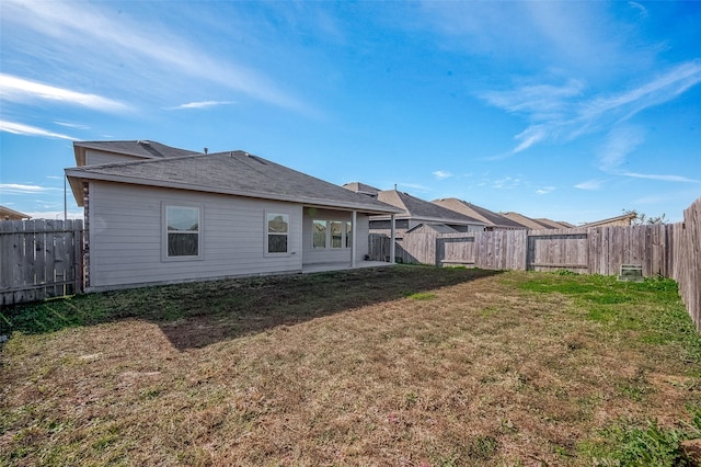 rear view of property featuring a yard