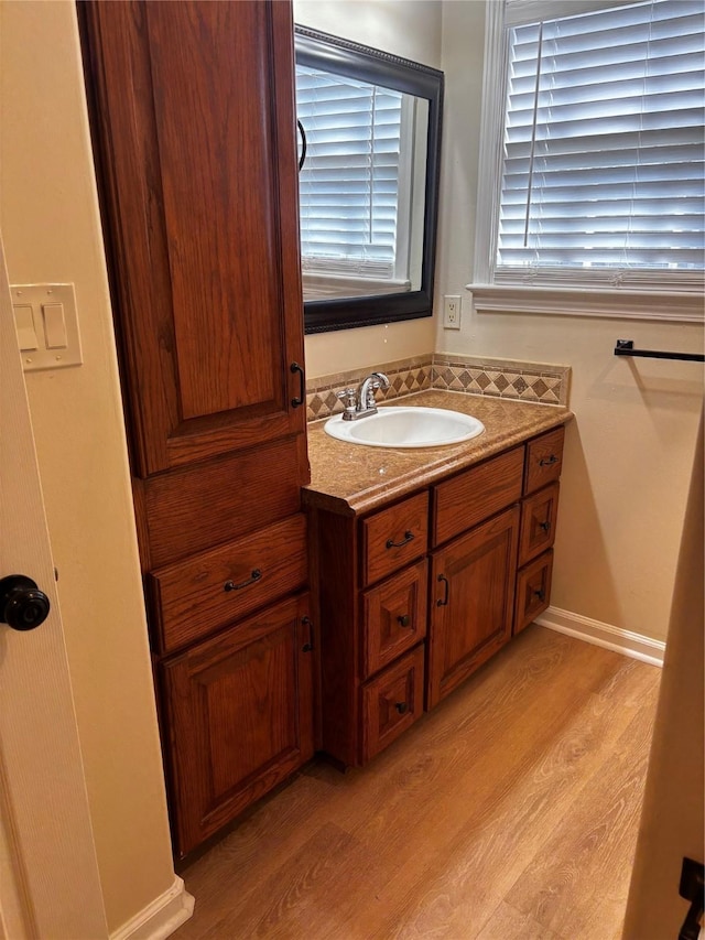 bathroom with hardwood / wood-style flooring and vanity