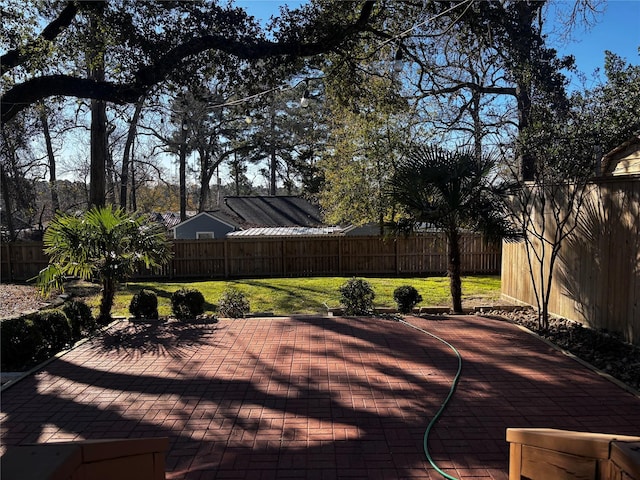 wooden terrace featuring a lawn and a patio