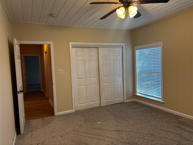 unfurnished bedroom featuring carpet, a closet, and ceiling fan