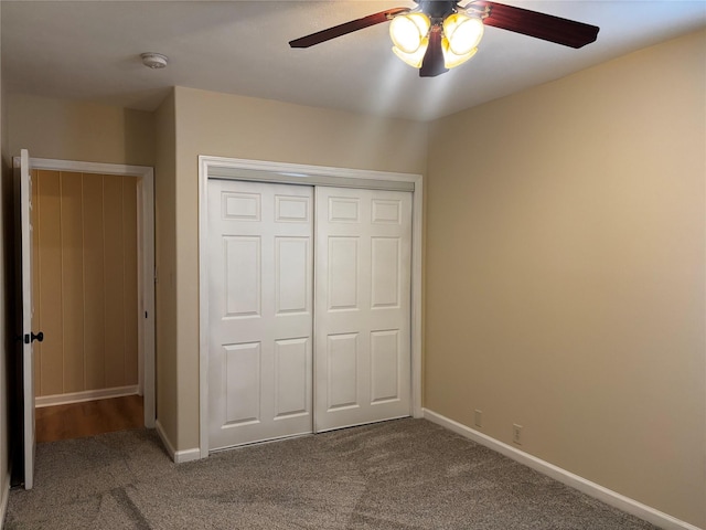 unfurnished bedroom with ceiling fan, a closet, and carpet floors