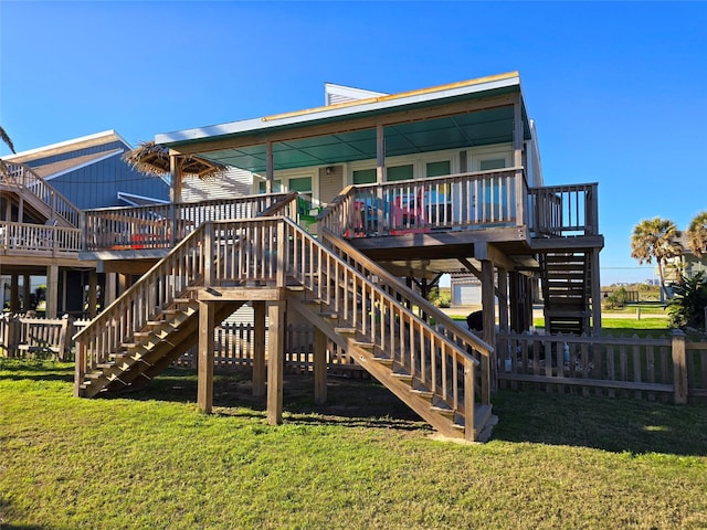 back of house featuring a lawn and a deck