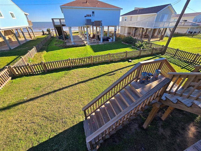 12929 John Reynolds Rd, Galveston, TX 77554 - exterior space with a deck with water view, a lawn, a fenced backyard, and stairway
