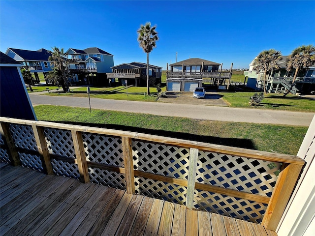 wooden terrace featuring a lawn