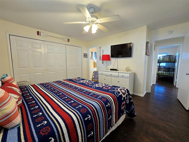 12929 John Reynolds Rd, Galveston, TX 77554 - bedroom featuring baseboards, a closet, dark wood-style floors, and ceiling fan
