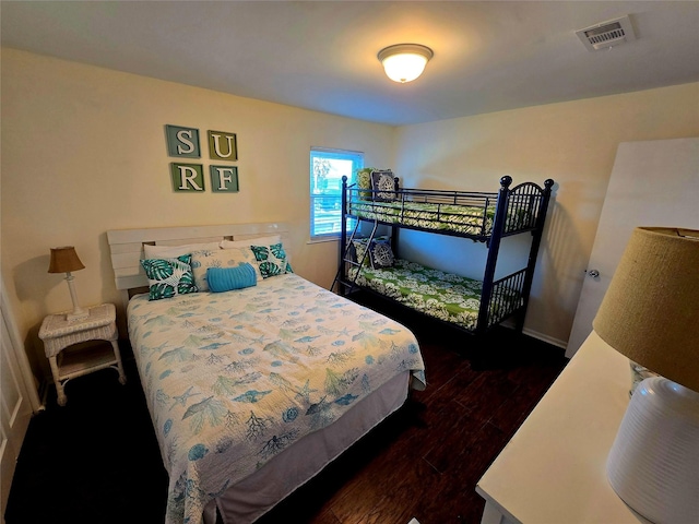 12929 John Reynolds Rd, Galveston, TX 77554 - bedroom featuring baseboards, visible vents, and dark wood-style floors