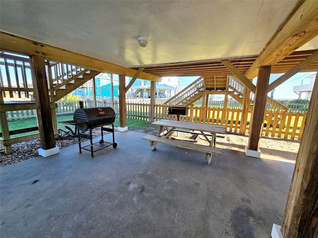 12929 John Reynolds Rd, Galveston, TX 77554 - view of patio featuring stairway, grilling area, and fence