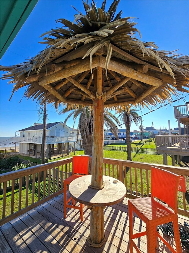 wooden terrace featuring a lawn