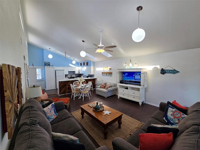 12929 John Reynolds Rd, Galveston, TX 77554 - living area with dark wood finished floors, lofted ceiling, a ceiling fan, and baseboards