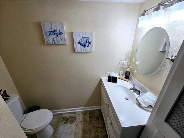 12929 John Reynolds Rd, Galveston, TX 77554 - half bathroom with baseboards, vanity, stone finish flooring, and toilet