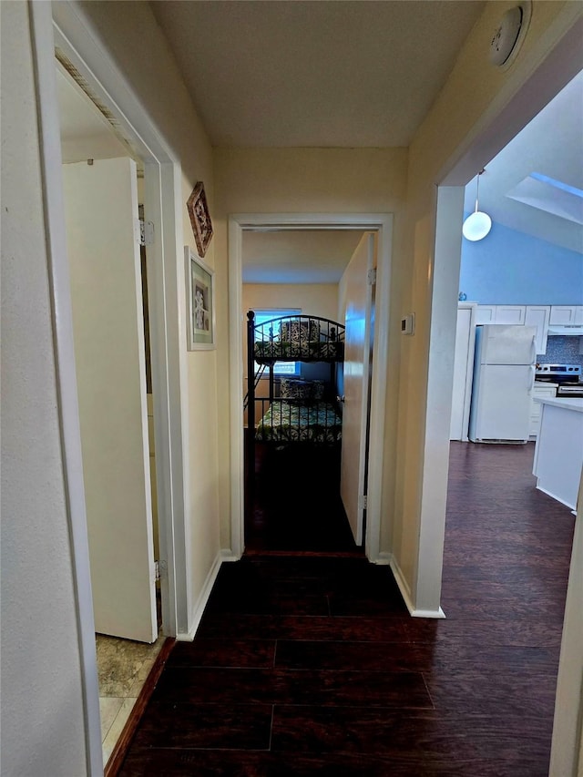 12929 John Reynolds Rd, Galveston, TX 77554 - corridor with baseboards and dark wood-style floors
