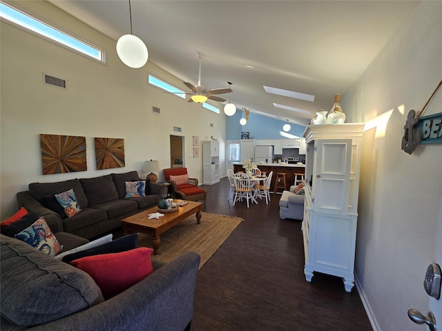 living room featuring dark wood-type flooring, ceiling fan, and high vaulted ceiling