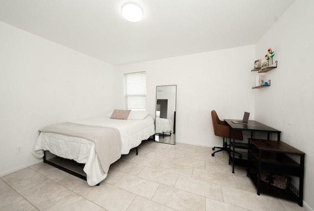 bedroom with light tile patterned floors