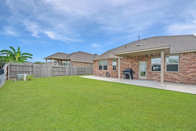 back of house featuring a lawn and a patio