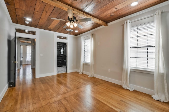 empty room with ceiling fan, beamed ceiling, crown molding, light hardwood / wood-style flooring, and wood ceiling