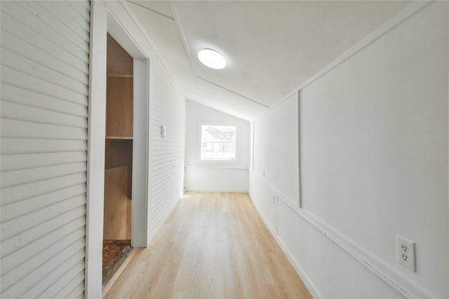 hallway featuring vaulted ceiling and light wood-type flooring