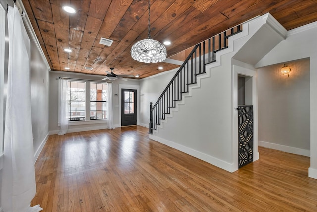 entrance foyer featuring ceiling fan, light wood-type flooring, wood ceiling, and crown molding