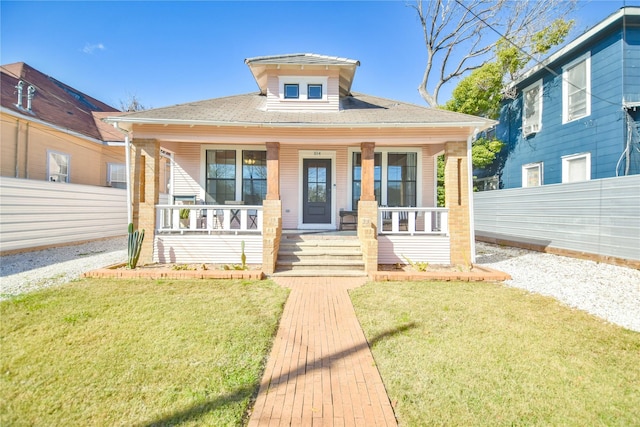 bungalow-style house with a front lawn and a porch