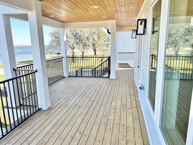 wooden deck featuring a water view