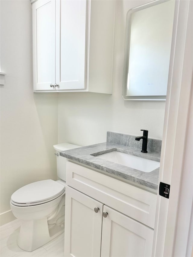 bathroom with toilet and vanity