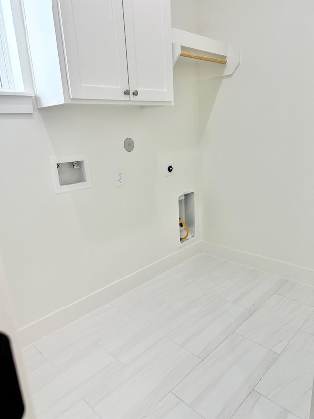 laundry room featuring hookup for a washing machine, cabinets, light tile patterned floors, and electric dryer hookup