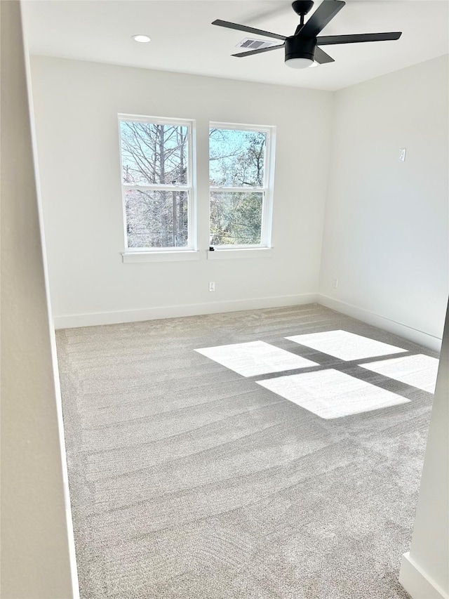 unfurnished room featuring ceiling fan and light colored carpet