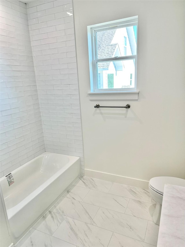 bathroom featuring toilet and bathing tub / shower combination