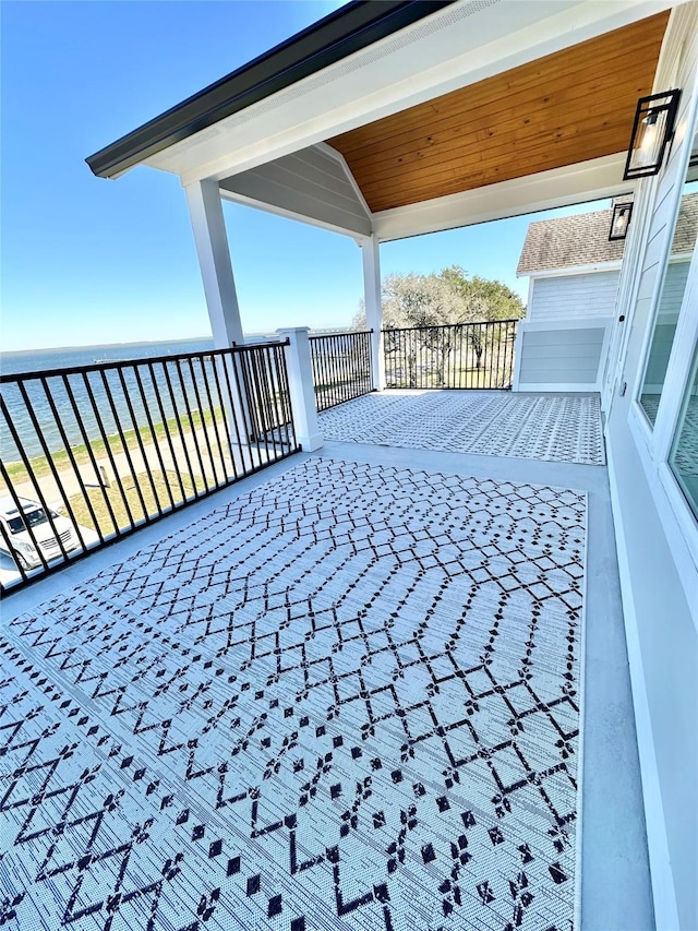 exterior space featuring a water view and a balcony