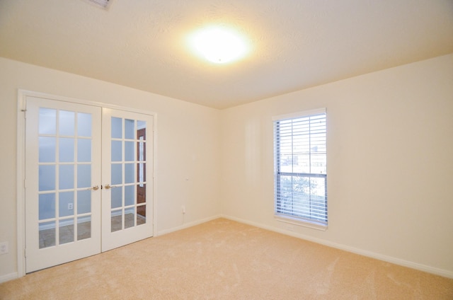 spare room with french doors and carpet flooring