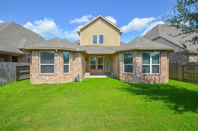 rear view of property with a yard