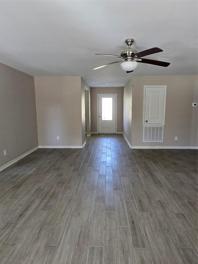 interior space with ceiling fan and dark hardwood / wood-style floors