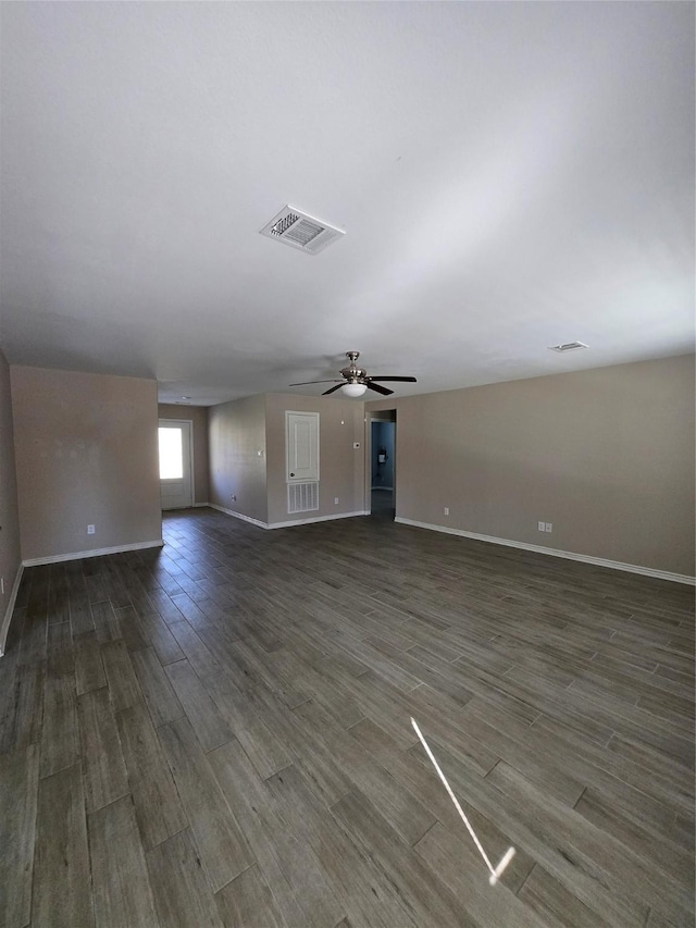 unfurnished living room featuring ceiling fan and dark hardwood / wood-style floors