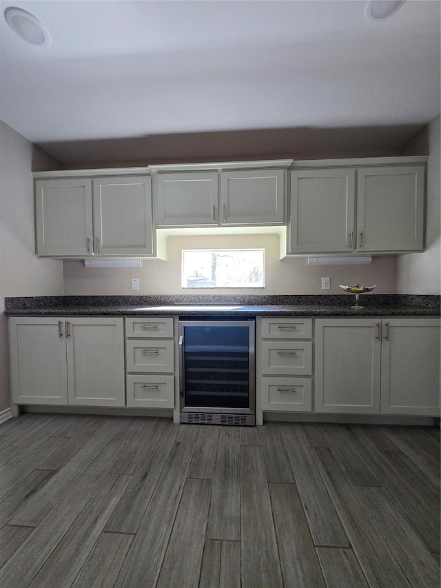 kitchen with white cabinetry, dark hardwood / wood-style floors, and wine cooler