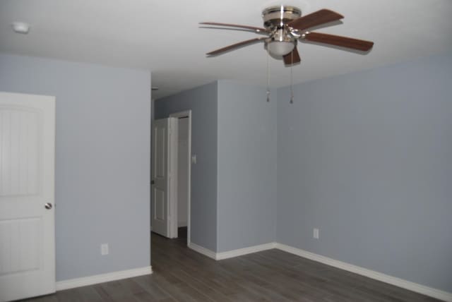 unfurnished room featuring ceiling fan and dark hardwood / wood-style flooring