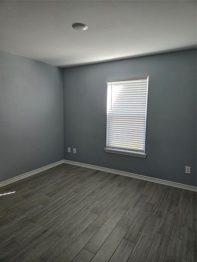 empty room with dark wood-type flooring