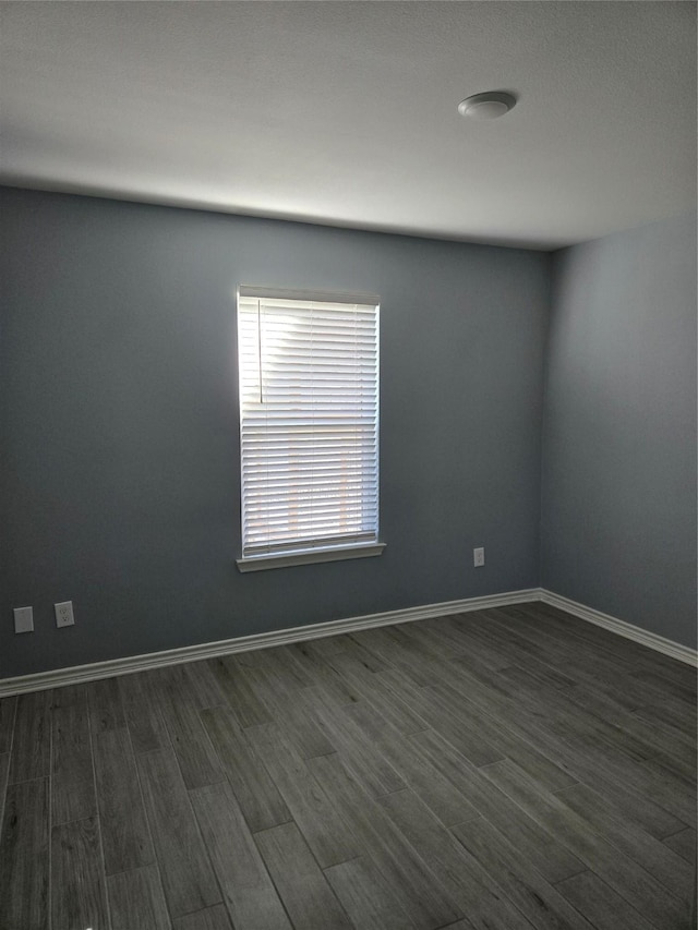 empty room with dark wood-type flooring