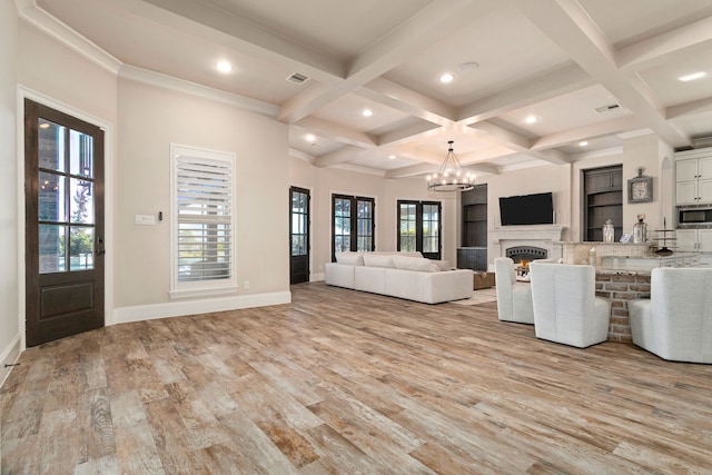 unfurnished living room with coffered ceiling, an inviting chandelier, beam ceiling, and light hardwood / wood-style flooring